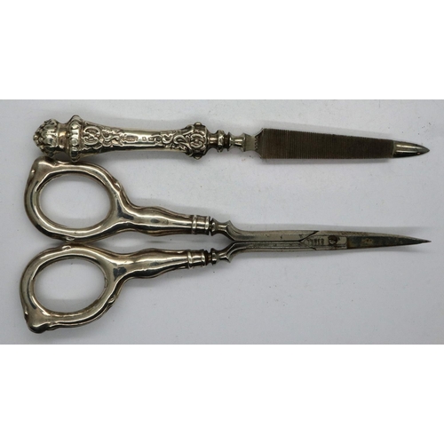 104 - Hallmarked silver handled nail scissors and nail file, Birmingham assay, largest L: 12 cm, 26g. P&P ... 