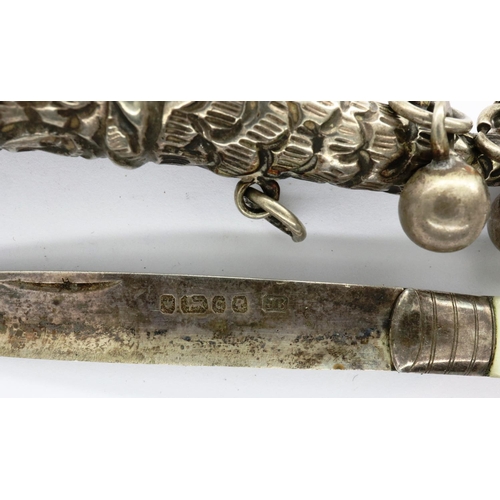 112 - Hallmarked silver and Mother of Pearl fruit knife and a presumed hallmarked silver rattle, largest L... 