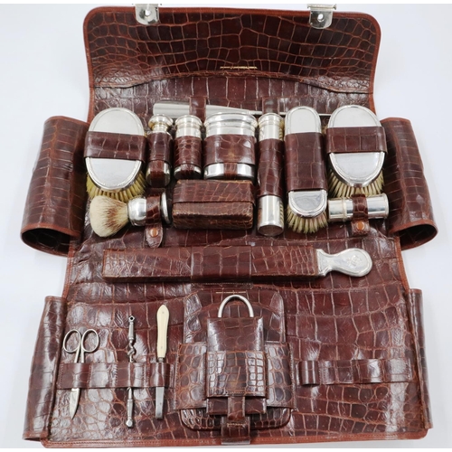 122 - 20th Century hallmarked silver gentlemans traveling set near complete in crocodile travel case. Trav... 