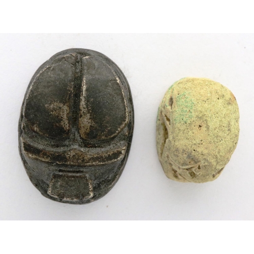 135 - Two Egyptians scarab talismans, one bone, one metal, largest L: 20 mm. P&P Group 0 (£5+VAT for the f... 