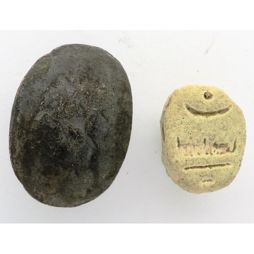 135 - Two Egyptians scarab talismans, one bone, one metal, largest L: 20 mm. P&P Group 0 (£5+VAT for the f... 