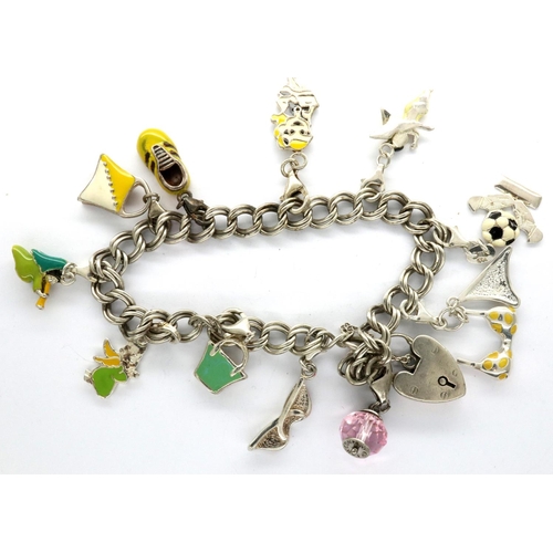 40 - Silver charm bracelet with hallmarked silver padlock clasp and eleven charms, L: 20 cm, 36g. P&P Gro... 