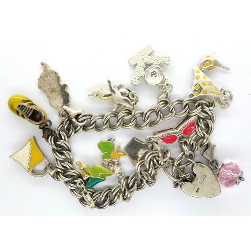 40 - Silver charm bracelet with hallmarked silver padlock clasp and eleven charms, L: 20 cm, 36g. P&P Gro... 