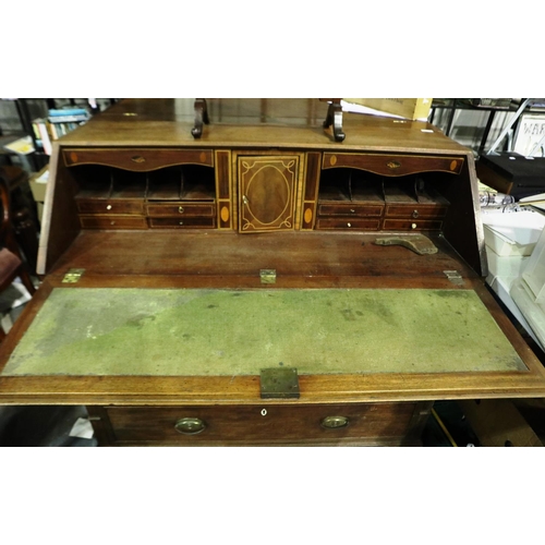 3100 - George III inlaid walnut bureau, the fall front with a complex interior of drawers, pigeon holes and... 