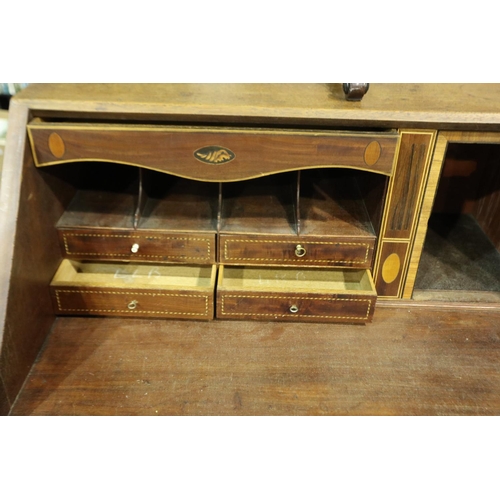 3100 - George III inlaid walnut bureau, the fall front with a complex interior of drawers, pigeon holes and... 