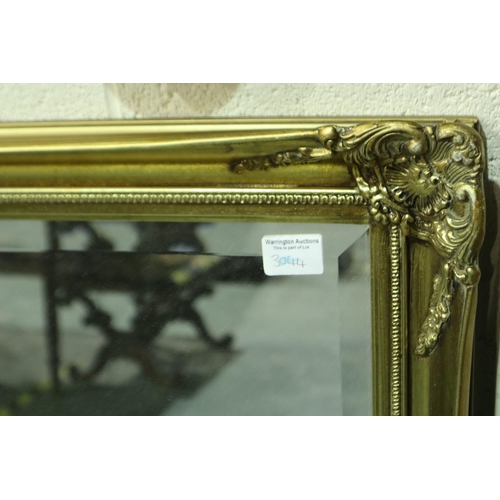 3131 - Large 20th century gilt framed bevelled edge mirror in good condition, 133 x 104 cm. Not available f... 