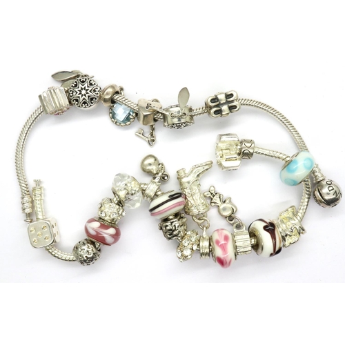 19 - Two Pandora charm bracelets, one with six charms and one with sixteen charms, clasp to one bracelet ... 