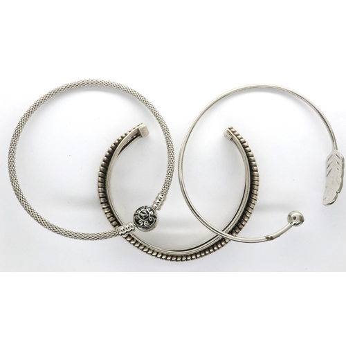 29 - Three 925 silver bangles including a torque example, largest D: 70 mm. P&P Group 1 (£14+VAT for the ... 