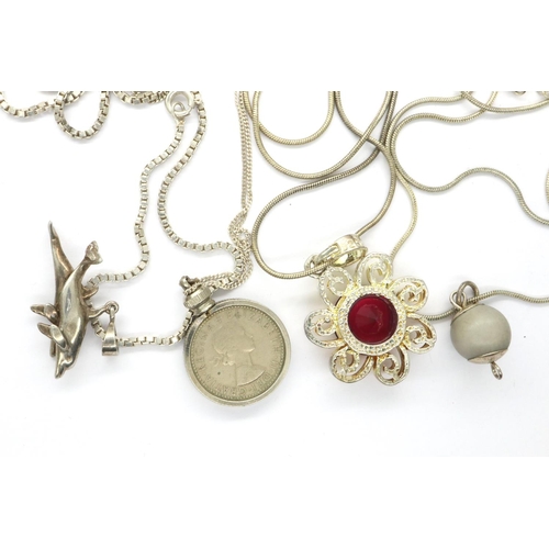 93 - Four pendants on 925 silver chains including a mounted sixpence pendant, longest chain L: 70 cm. P&P... 