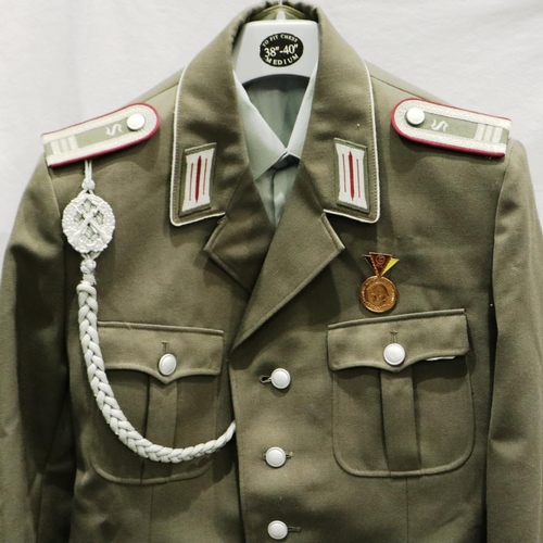 2076 - East German Armoured Division NCO uniform, comprising tunic, trousers, boots, and visor cap with lan... 