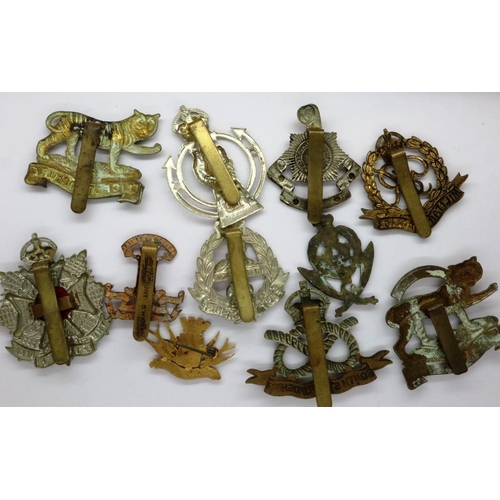 2146 - Four WWI British military cap badges and enamelled sweetheart badge and six British WWII cap badges,... 