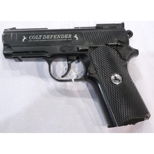 2202 - Colt Defender Co2 air pistol, cased, with cartridges, targets and BBs. P&P Group 3 (£25+VAT for the ... 