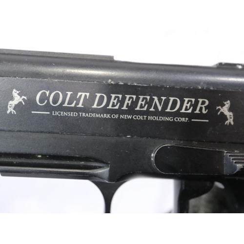 2202 - Colt Defender Co2 air pistol, cased, with cartridges, targets and BBs. P&P Group 3 (£25+VAT for the ... 