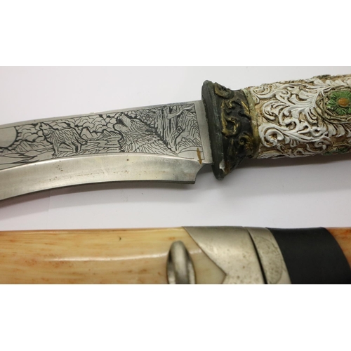 2207 - A modern Bowie style hunting knife with engraved blade and carved handle (lacking scabbard), togethe... 