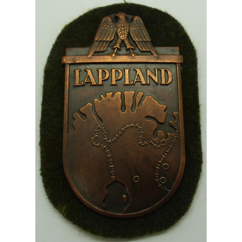 2170V - Lappland bronze arm shield, mounted onto cloth. P&P Group 1 (£14+VAT for the first lot and £1+VAT fo... 