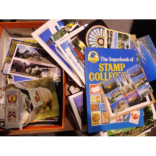 1123 - Large quantity of postcards, loose stamps, The Superbook of Stamp Collecting and a further stamp alb... 