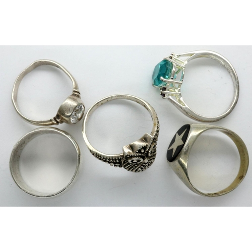 23 - Four stone set silver rings and a silver band, combined 22g (5). P&P Group 1 (£14+VAT for the first ... 