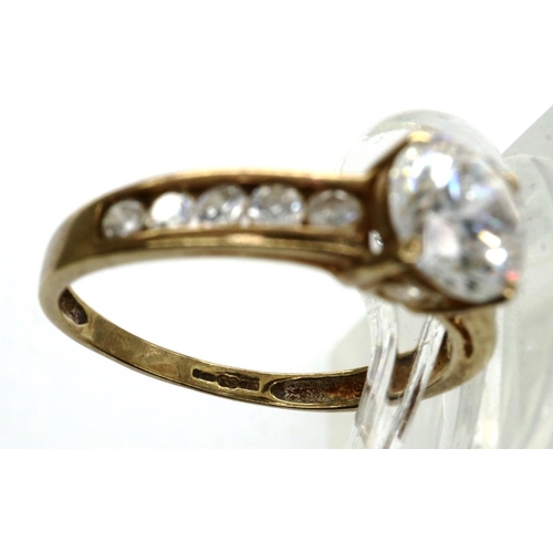 29 - 9ct gold and CZ solitaire ring with channel set shoulders, size N, 1.8g. P&P Group 1 (£14+VAT for th... 