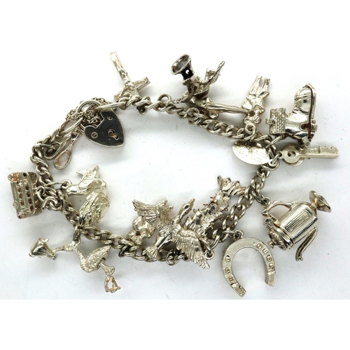 35 - 925 silver charm bracelet with hallmarked silver padlock clasp and fifteen charms, chain L: 18 cm. P... 