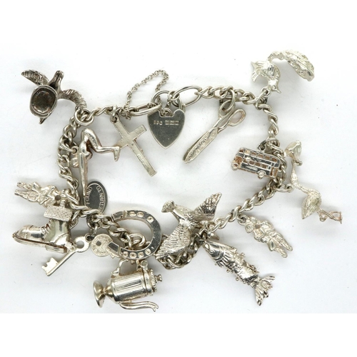 35 - 925 silver charm bracelet with hallmarked silver padlock clasp and fifteen charms, chain L: 18 cm. P... 