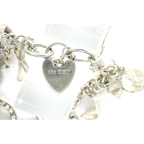 35 - 925 silver charm bracelet with hallmarked silver padlock clasp and fifteen charms, chain L: 18 cm. P... 