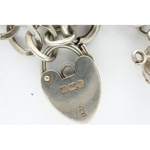 37 - 925 silver charm bracelet with hallmarked silver padlock clasp and twelve charms, chain L: 18 cm. P&... 