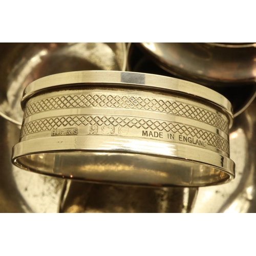 116 - Five napkin rings (three hallmarked silver), a silver candlestick and a silver plated dish marked Gl... 