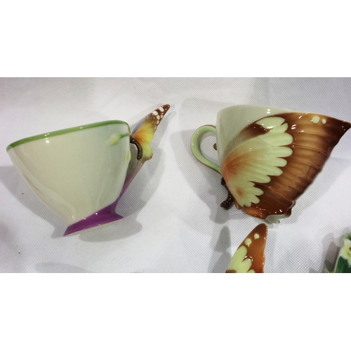 257 - Two Franz butterfly cups and saucers, and a butterfly teaspoon and vase, no chips or cracks, no craz... 