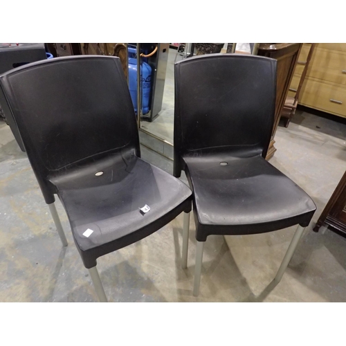 1542 - Two plastic stacking chairs. Not available for in-house P&P