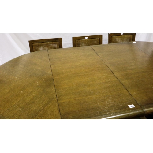 2091 - A modern oak circular extending dining table with two additional leaves and a set of eight chairs wi... 