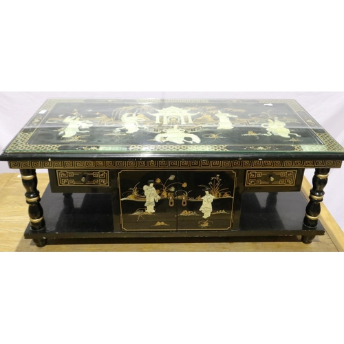 2094 - A 20th century black lacquered Oriental coffee table, glass top above a Shibyama and gilt panel with... 