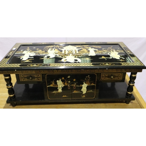 2094 - A 20th century black lacquered Oriental coffee table, glass top above a Shibyama and gilt panel with... 