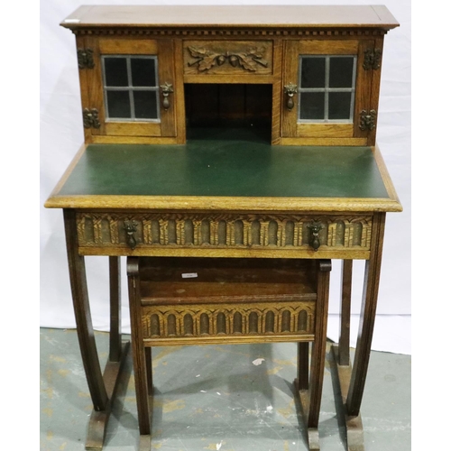 2103 - An early 20th century oak writing desk, gadrooned in the priory style with two drawers (one conceale... 