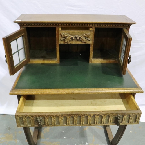 2103 - An early 20th century oak writing desk, gadrooned in the priory style with two drawers (one conceale... 