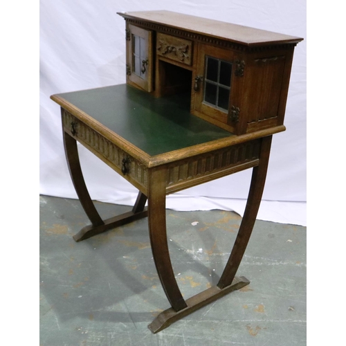 2103 - An early 20th century oak writing desk, gadrooned in the priory style with two drawers (one conceale... 