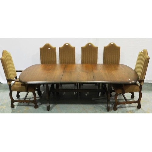 2105 - A 20th century Spanish oak extending dining table with a set of ten upholstered high back dining cha... 