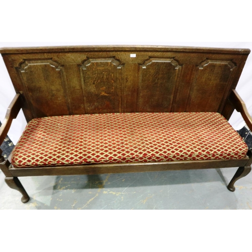 2108 - An 18th/19th century panelled oak settee with later upholstered seat cushion, L: 185 cm. Not availab... 