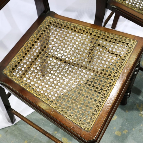 2109 - Pair of early 20th century mahogany bedroom chairs, each with bergere seats and turned supports. Not... 