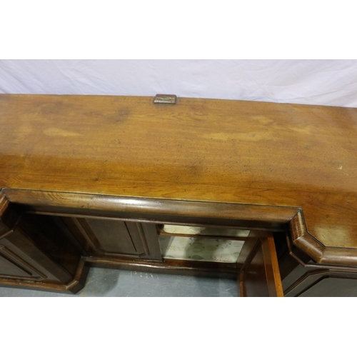 2118 - 19th century walnut sideboard, with inverted break-front, having four panelled doors and cellarette ... 