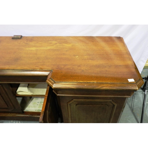 2118 - 19th century walnut sideboard, with inverted break-front, having four panelled doors and cellarette ... 