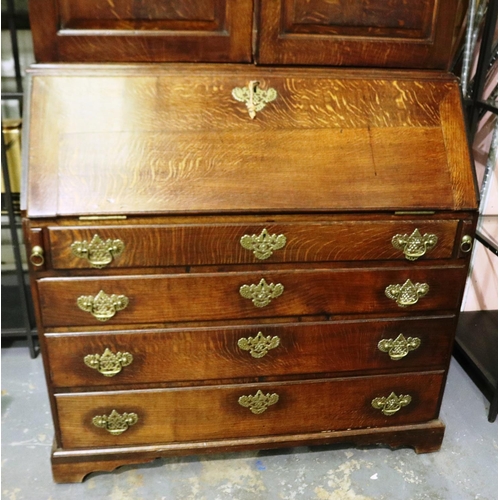 2128 - An early 19th century oak bureau bookcase with fitted interior of drawers, pigeon holes and conceale... 