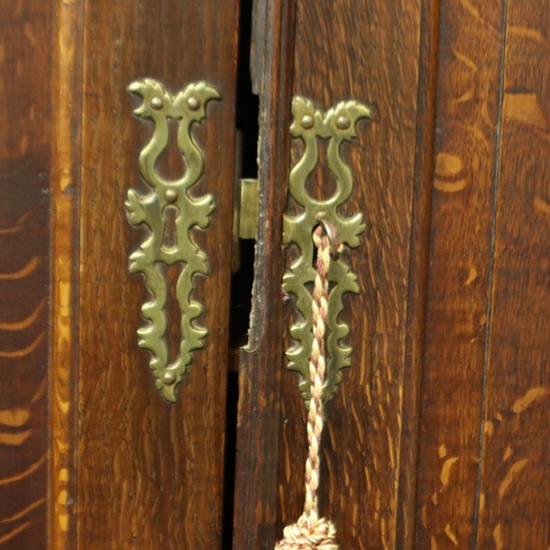 2128 - An early 19th century oak bureau bookcase with fitted interior of drawers, pigeon holes and conceale... 