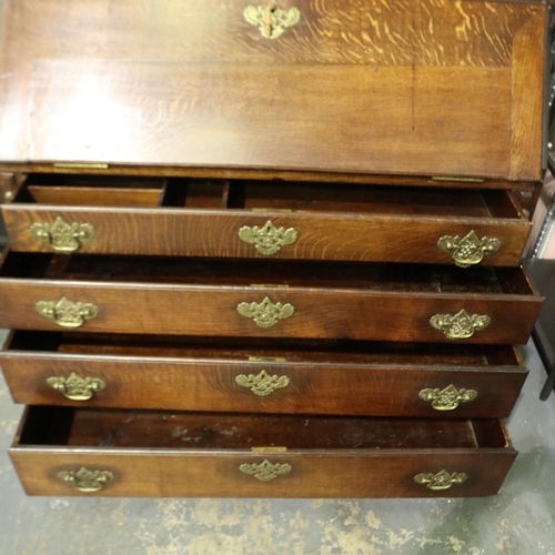 2128 - An early 19th century oak bureau bookcase with fitted interior of drawers, pigeon holes and conceale... 