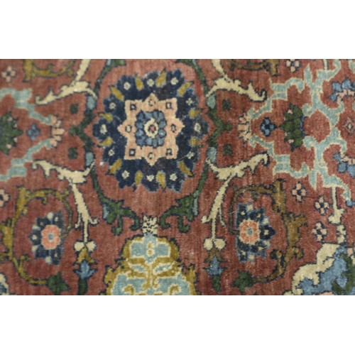 2084 - A 19th Century Eastern woollen floor rug with floral designs against a dark red ground, 145 x 90 cm.... 