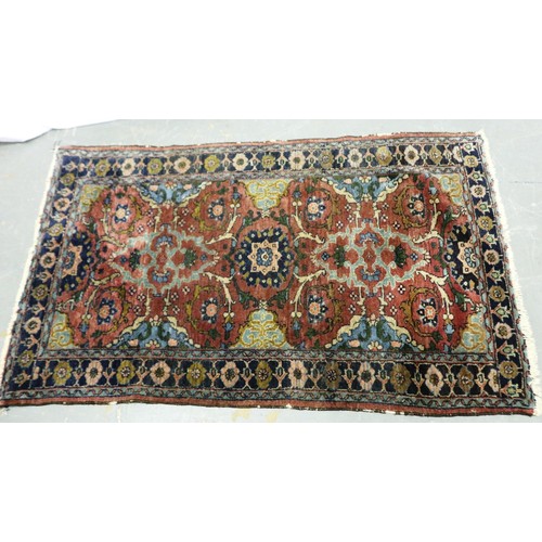 2084 - A 19th Century Eastern woollen floor rug with floral designs against a dark red ground, 145 x 90 cm.... 