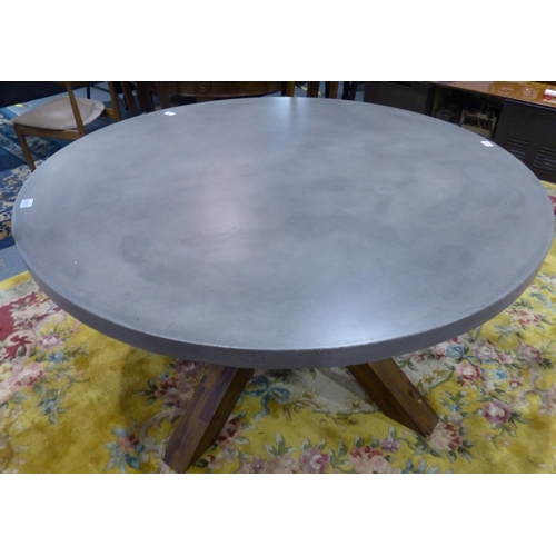 2080 - A contemporary pine and reconstituted stone dining table, with star form supports and polished circu... 