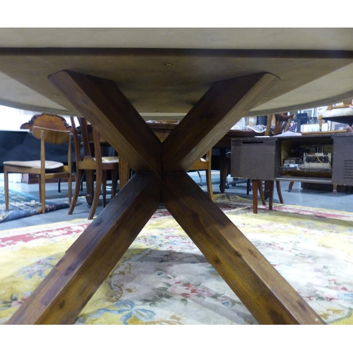 2080 - A contemporary pine and reconstituted stone dining table, with star form supports and polished circu... 