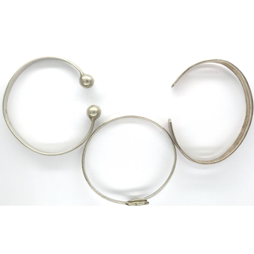 44 - Three 925 silver bangles including two torque examples, largest D: 70 mm. P&P Group 1 (£14+VAT for t... 