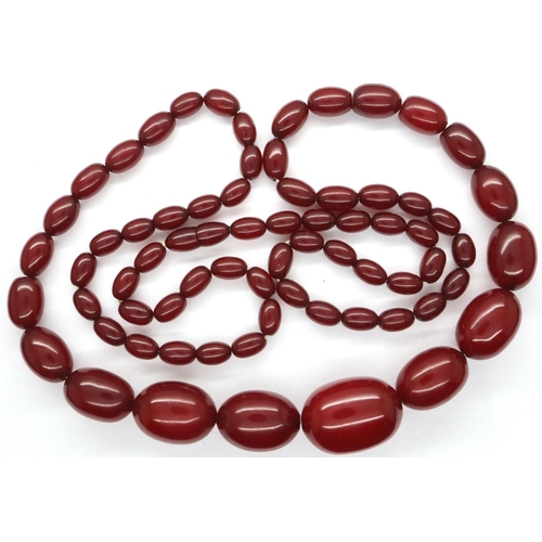 62 - Cherry amber bead necklace, L: 100 cm, largest bead L: 30 mm, 89g. Amber marbles when backlit, large... 