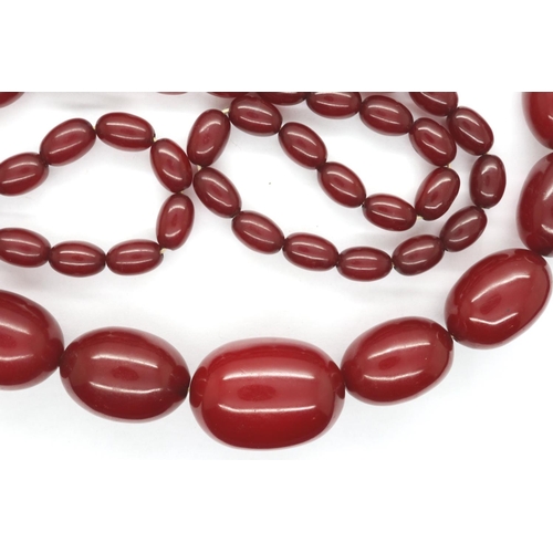 62 - Cherry amber bead necklace, L: 100 cm, largest bead L: 30 mm, 89g. Amber marbles when backlit, large... 